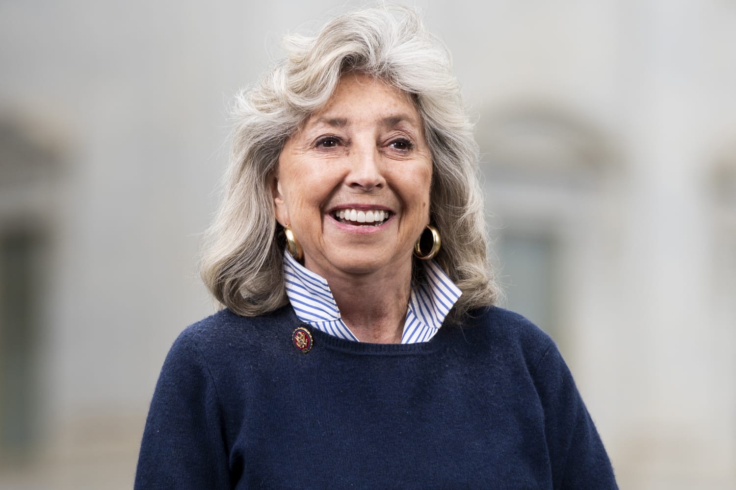 Dina Titus in navy sweater in front of a blurred background.