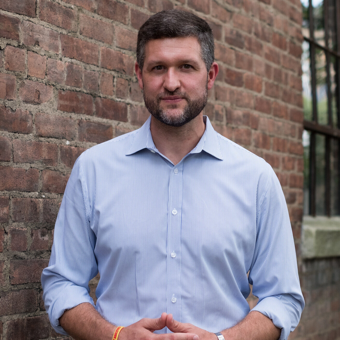 Pat Ryan in front of brick building